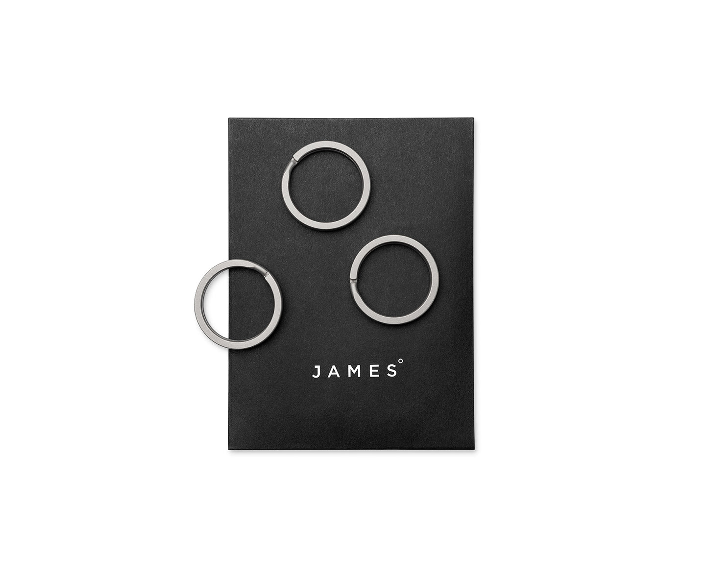 Three titanium key rings on their packaging.
